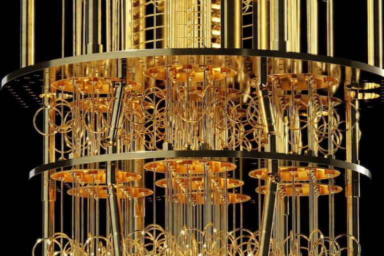 Close-up view of a quantum processor suspended inside a cryogenic dilution refrigerator, showing intricate gold-colored wiring and circular components. The image represents ultra-cold environments used for quantum computing research, such as experiments conducted by MIT Plasma Science and Fusion Center on superconducting diode circuits.